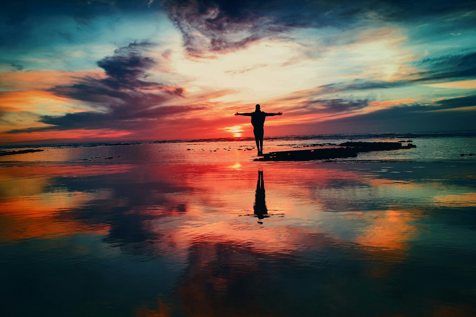 Worshipers lifting their hands toward a sunrise sky