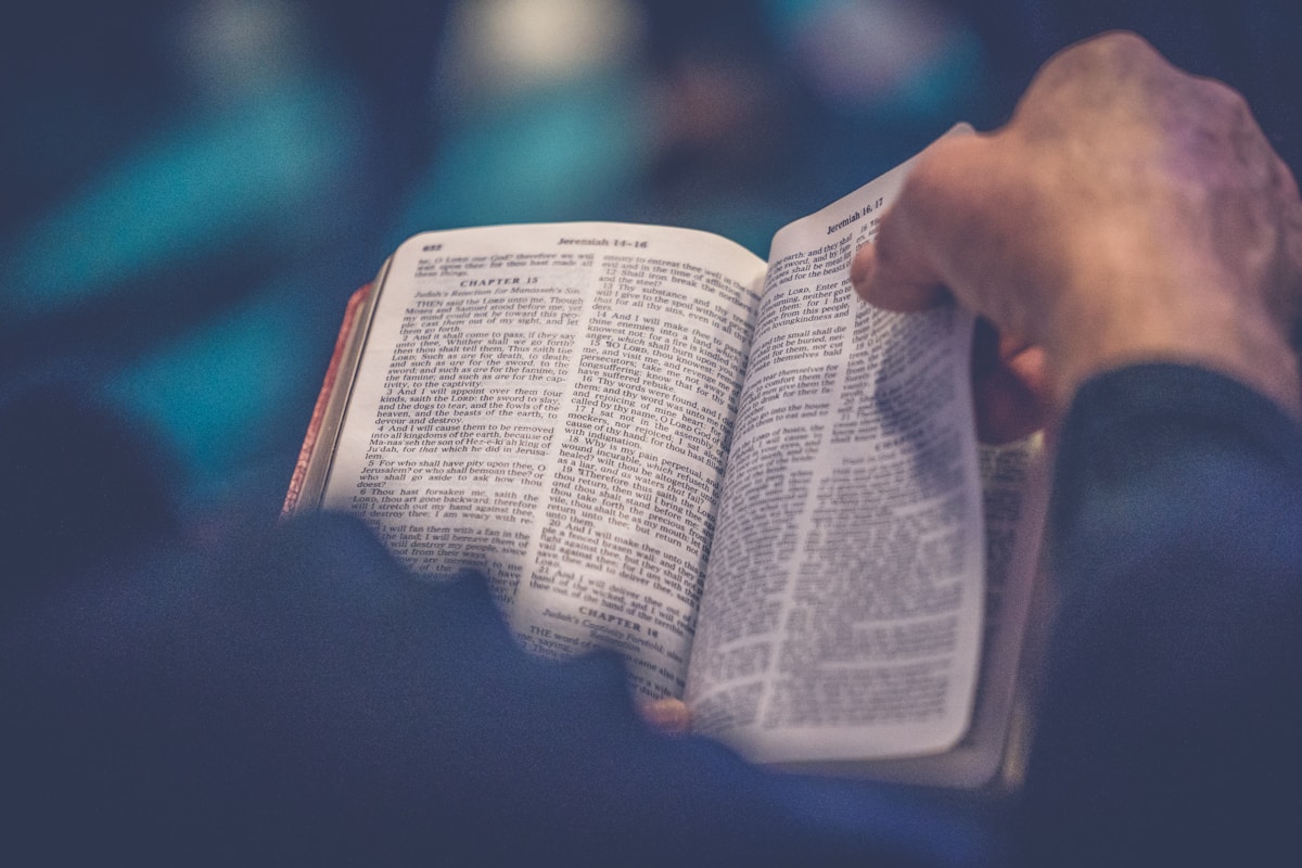 Hands resting on an open Bible during a small-group study