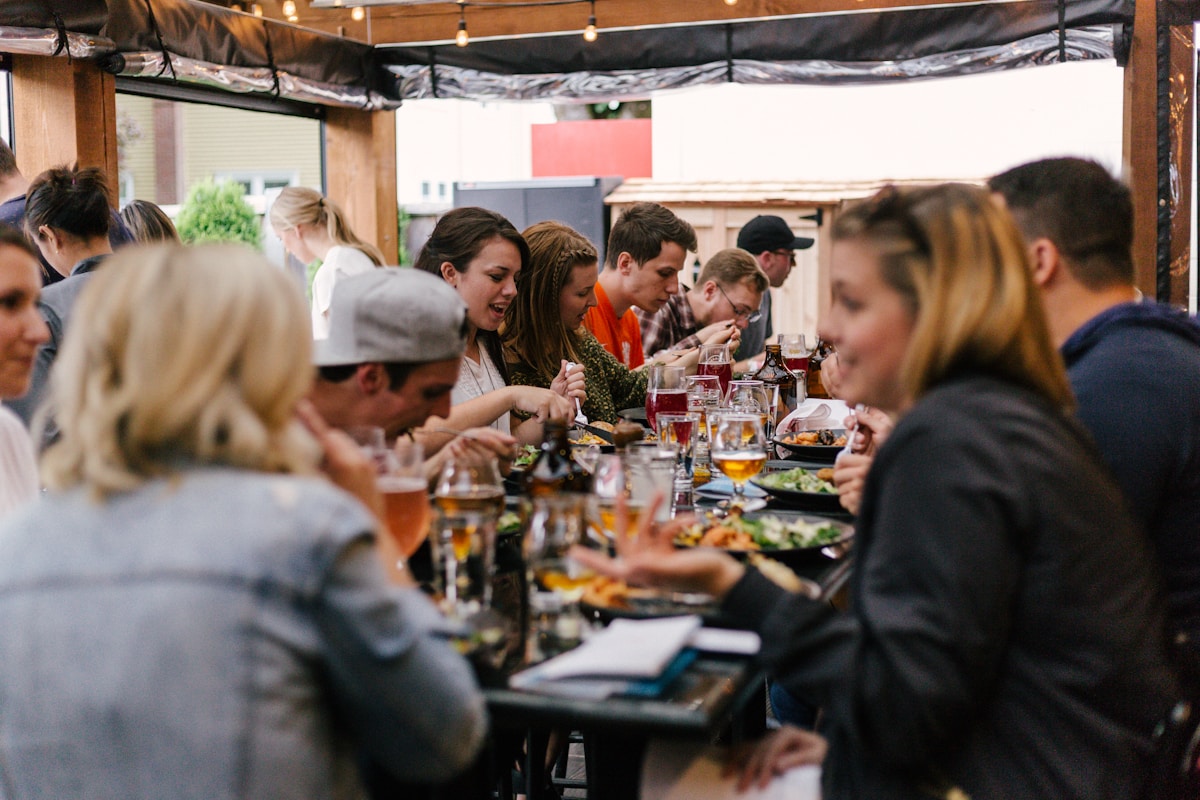 Church members sharing a potluck meal together around a long table