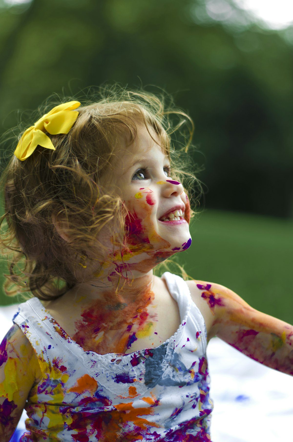 Children laughing and playing together outdoors in the sunshine