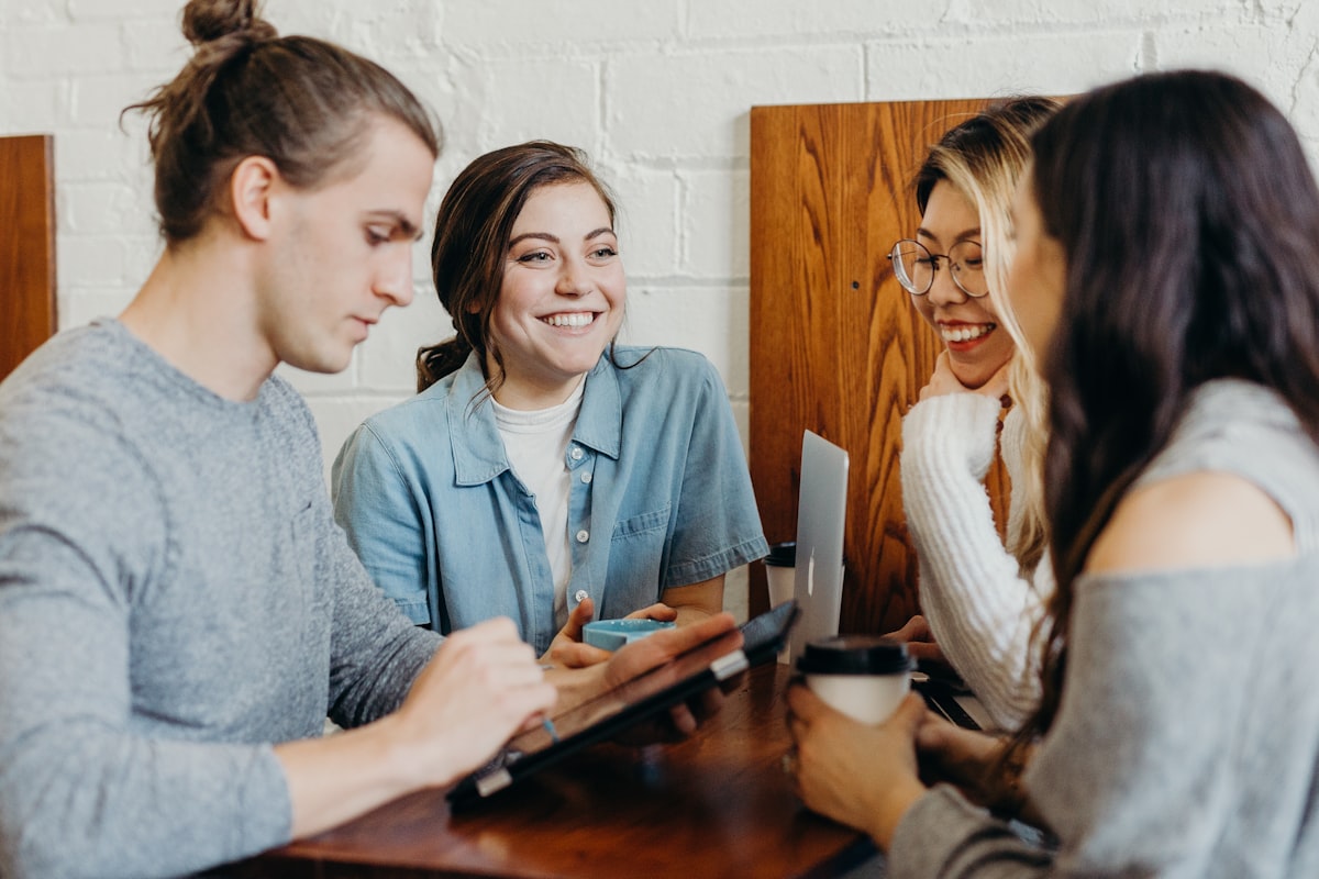 A small group of friends studying together around a table
